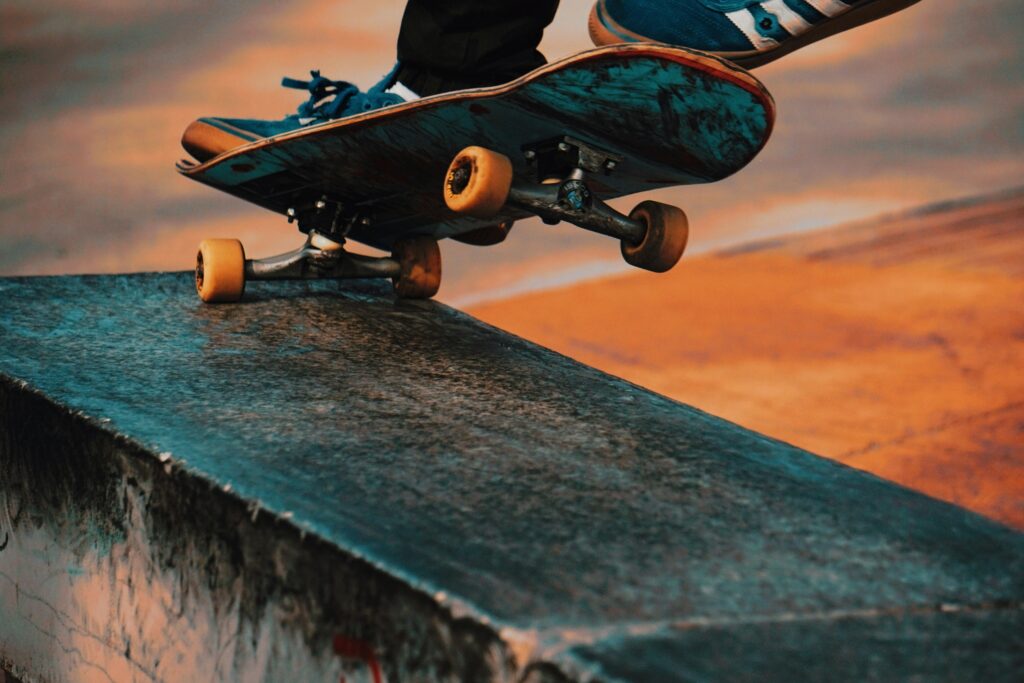 A skateboarder doing a back truck grind on a concrete ledge. 